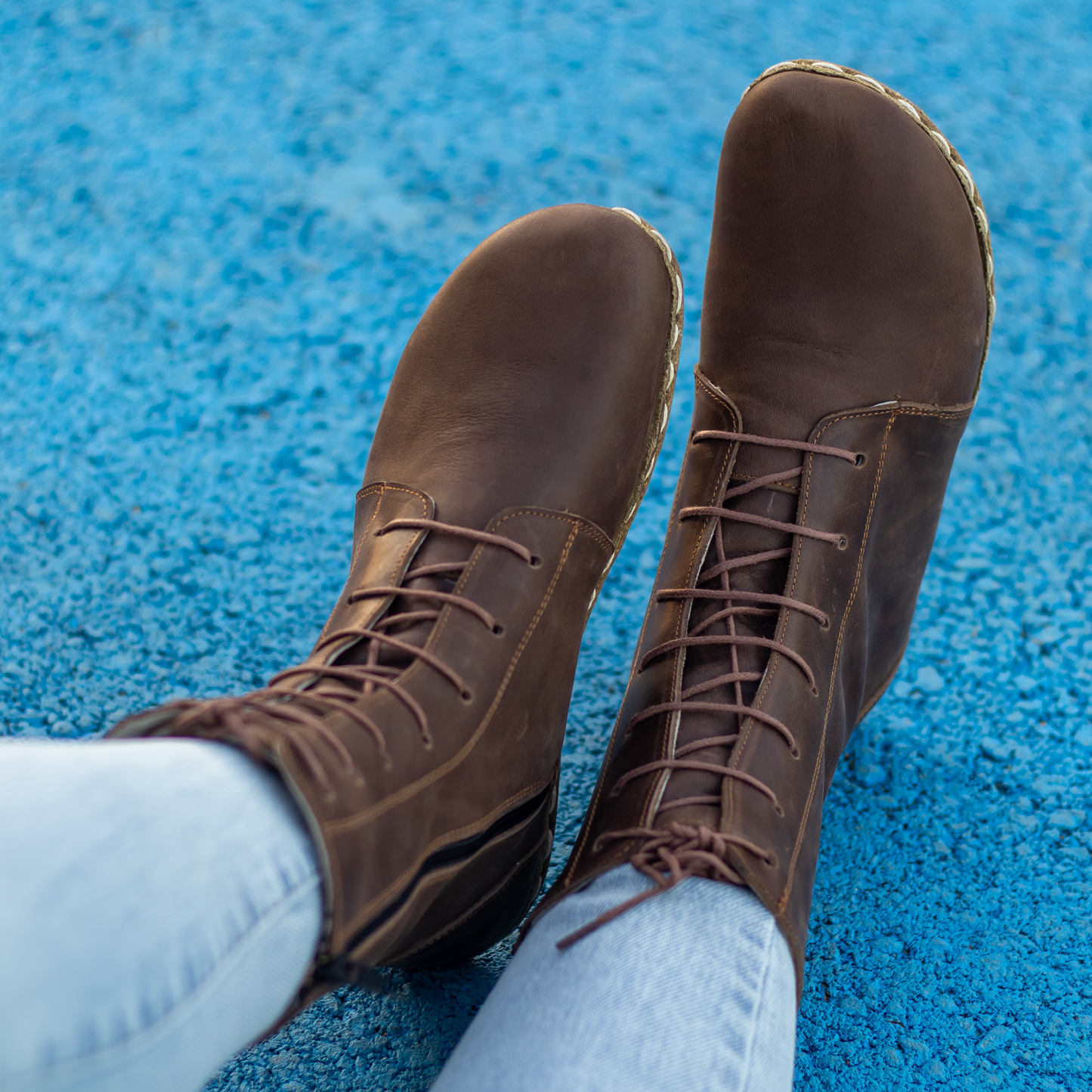 Brown leather boots with laces, showcasing grounded elegance for women, perfect for natural movement.