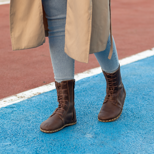 Barefoot grounding effect brown leather boots for women, showcasing natural elegance and comfort in outdoor setting.