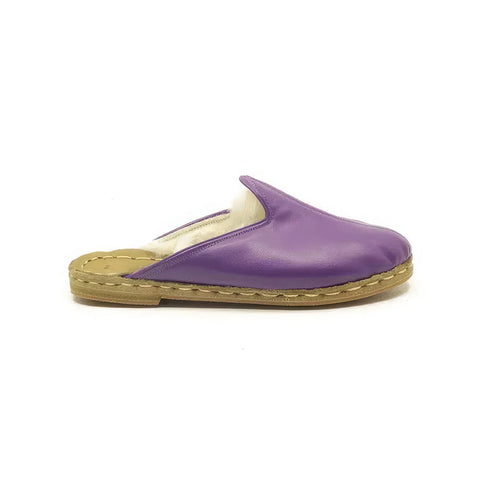 Purple slipper with beige sole on a white background