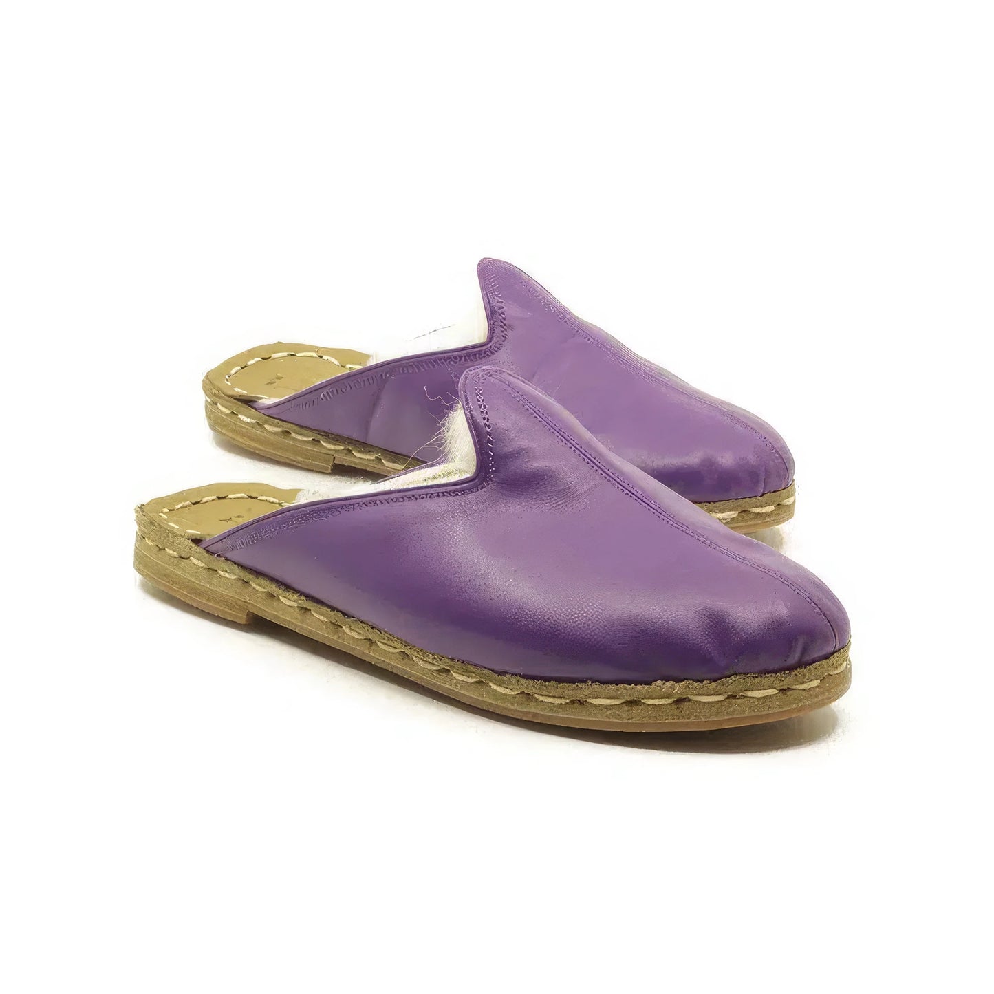 Pair of purple leather slippers on a white background